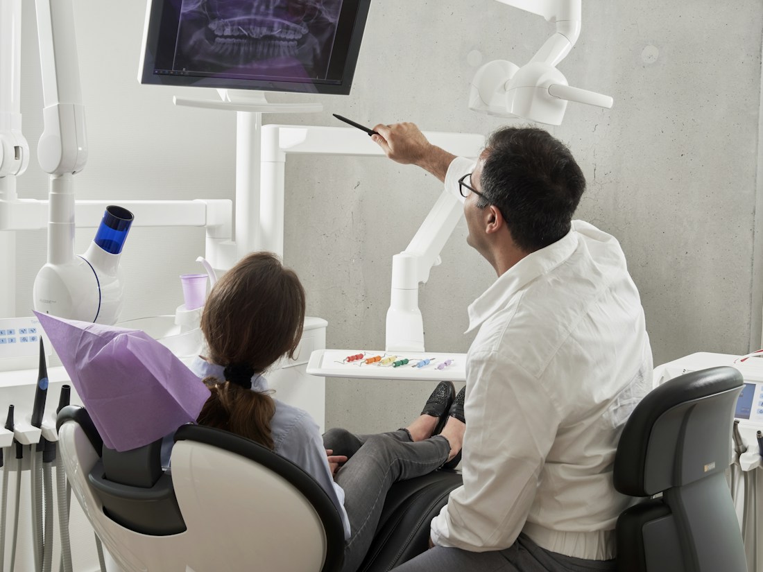 Dentist discussing an X-ray with an adult patient