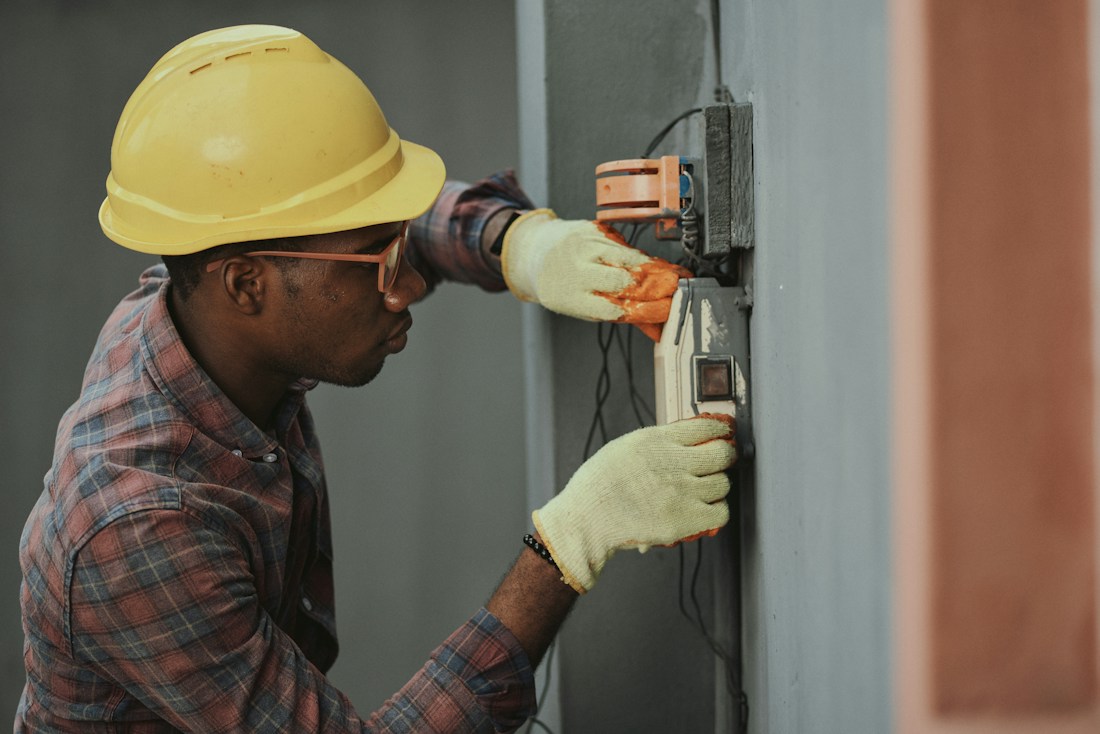 Technician wearing a hard hat working on equipment